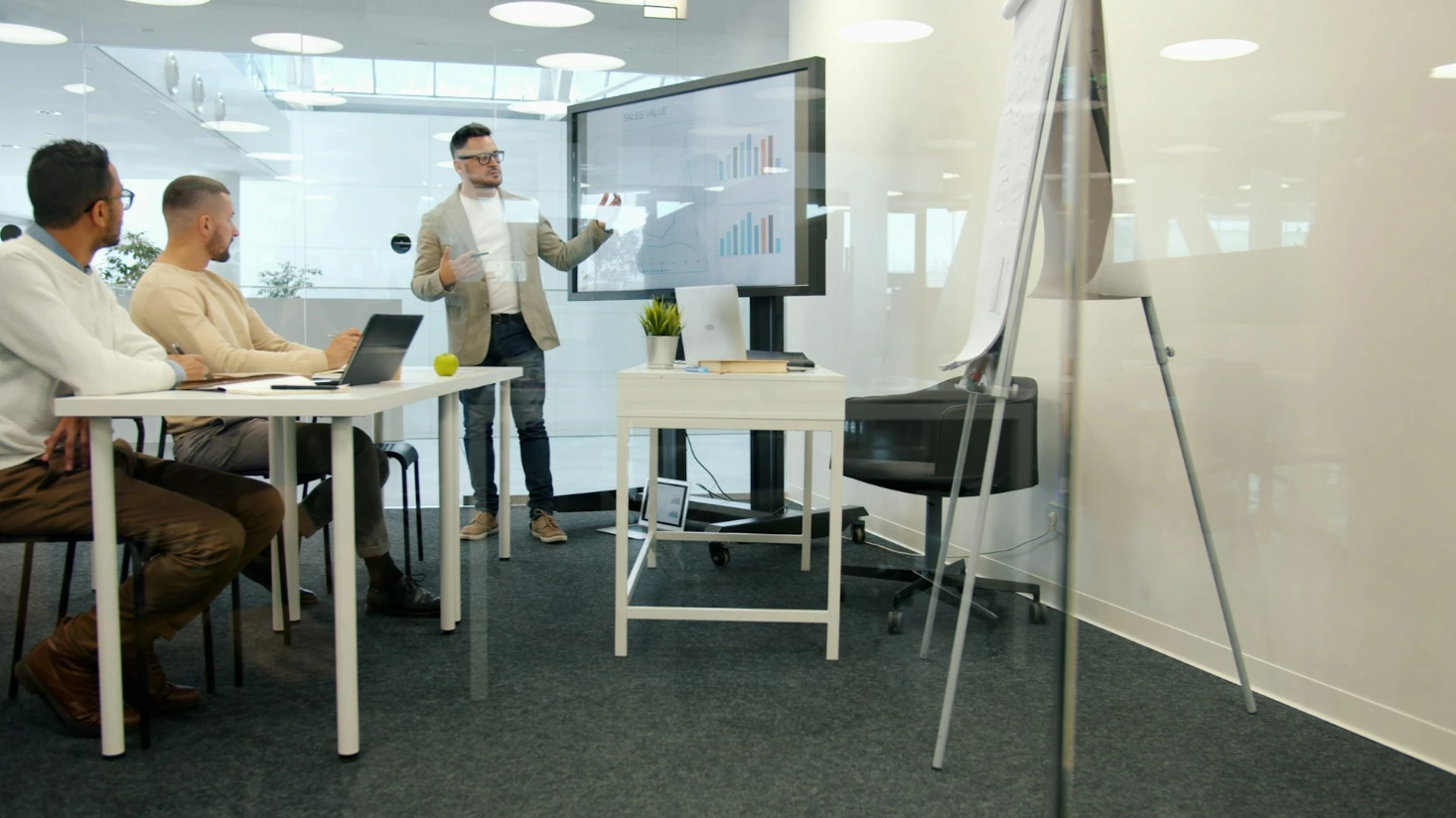 Man presenting to colleagues in a modern office