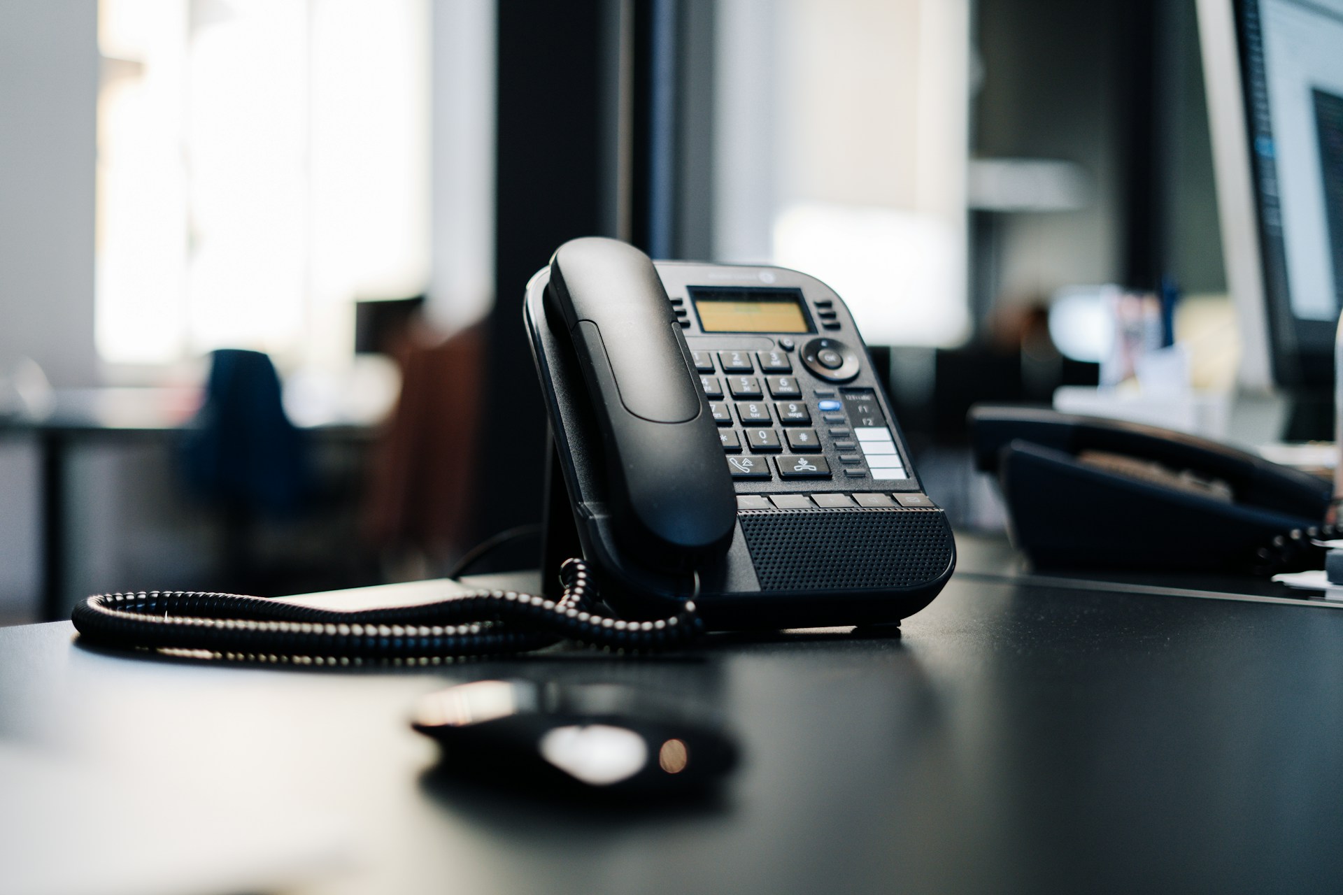 Black office phone on desk