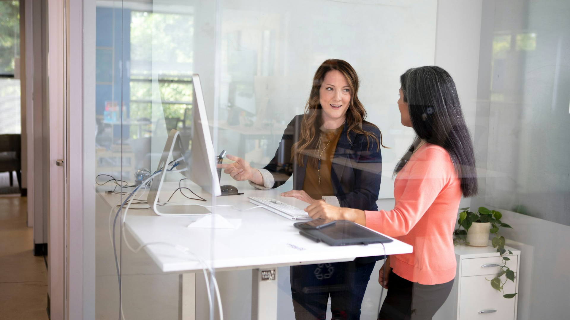 2 women sitting at table