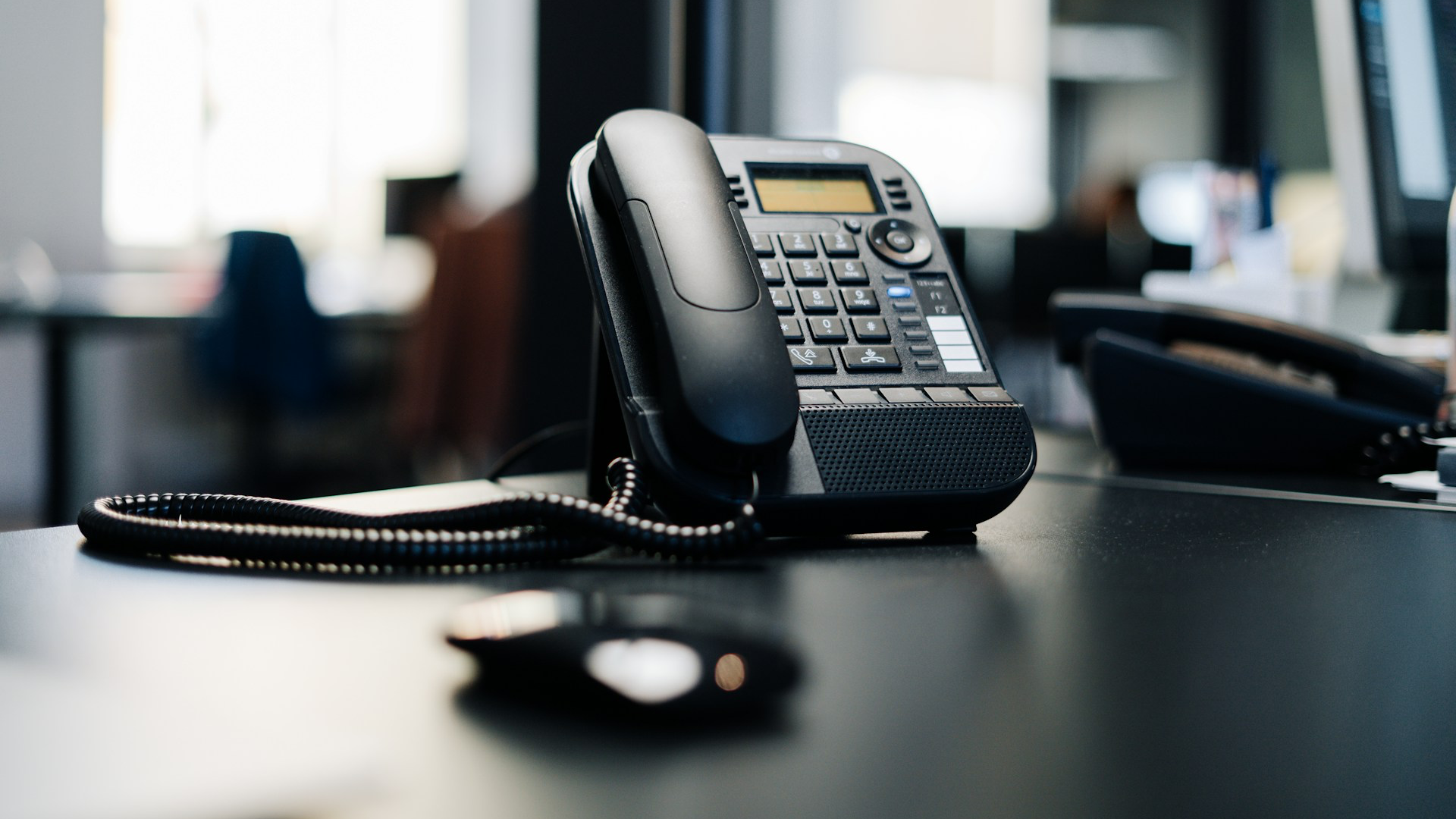 business phone systems Black office phone on desk